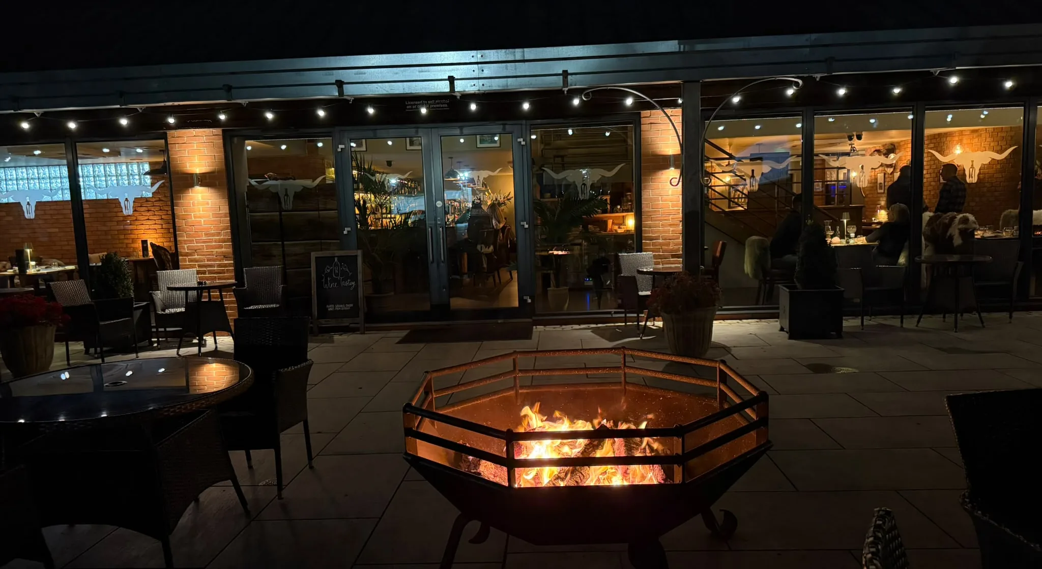 The fire pit blazing on The Longhorn terrace after dark